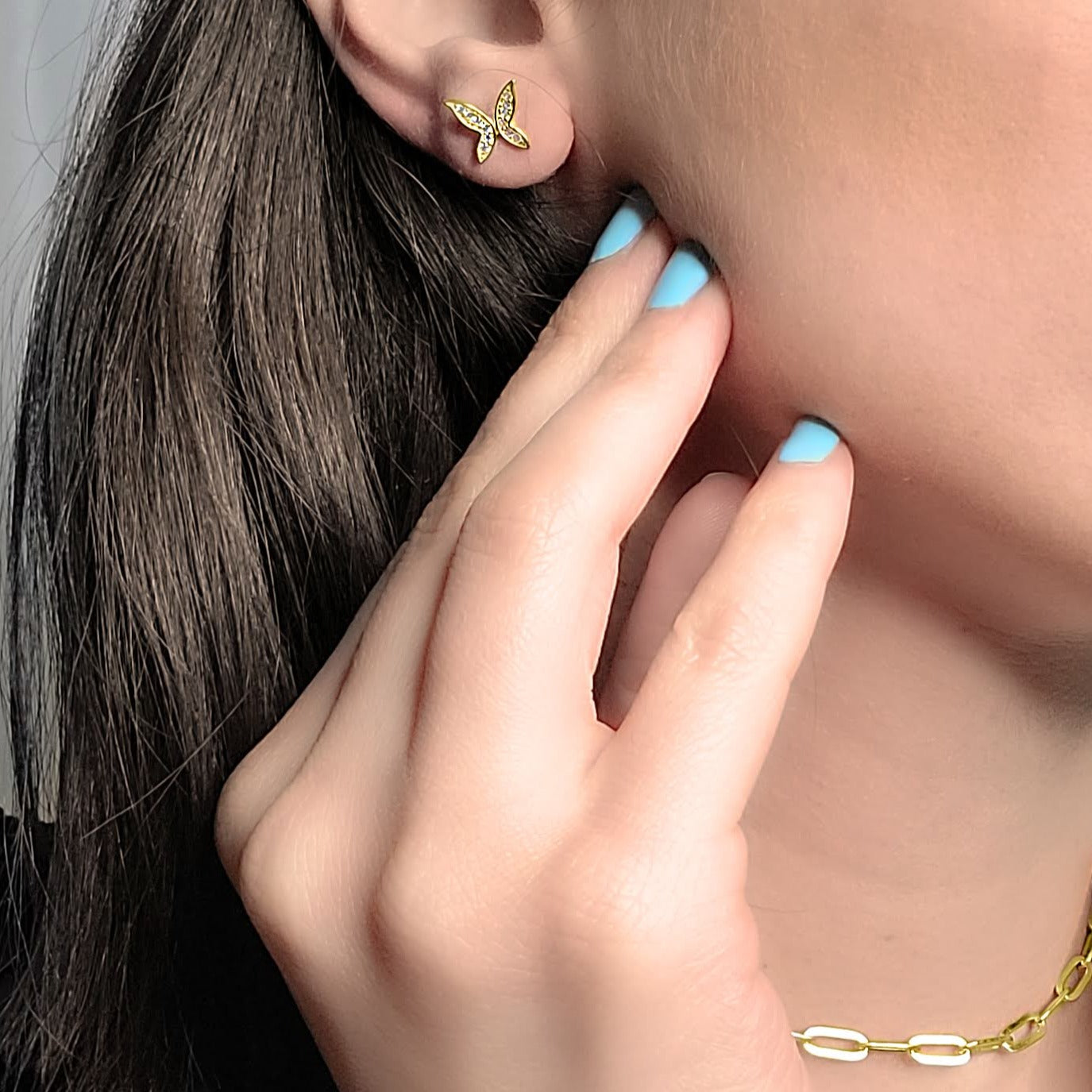 Woman wearing butterfly studs