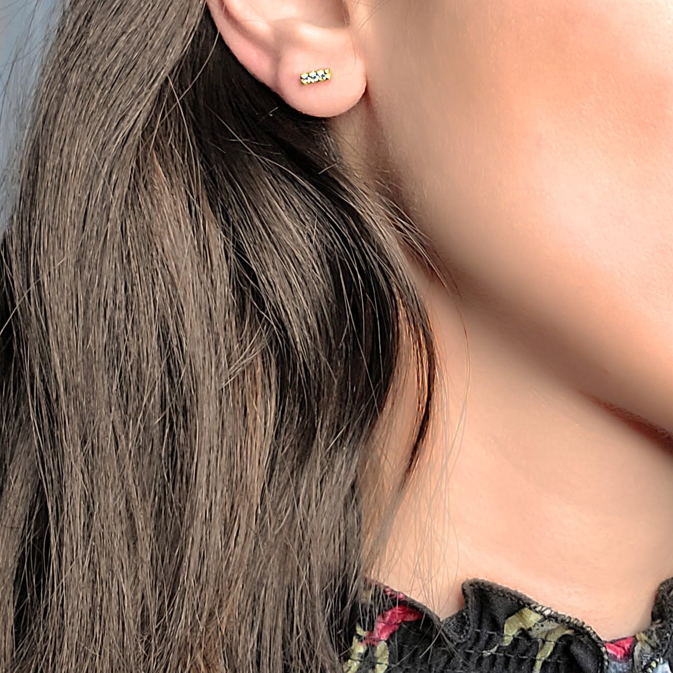 Woman wearing cubic studs