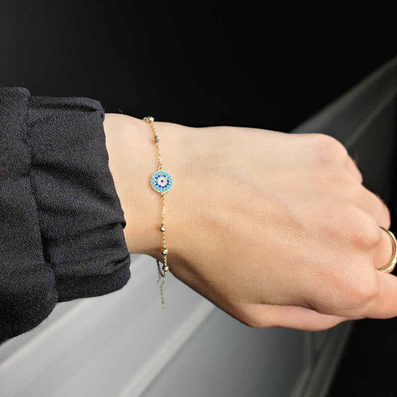 Woman wearing 10kt yellow gold Evil eye bracelet