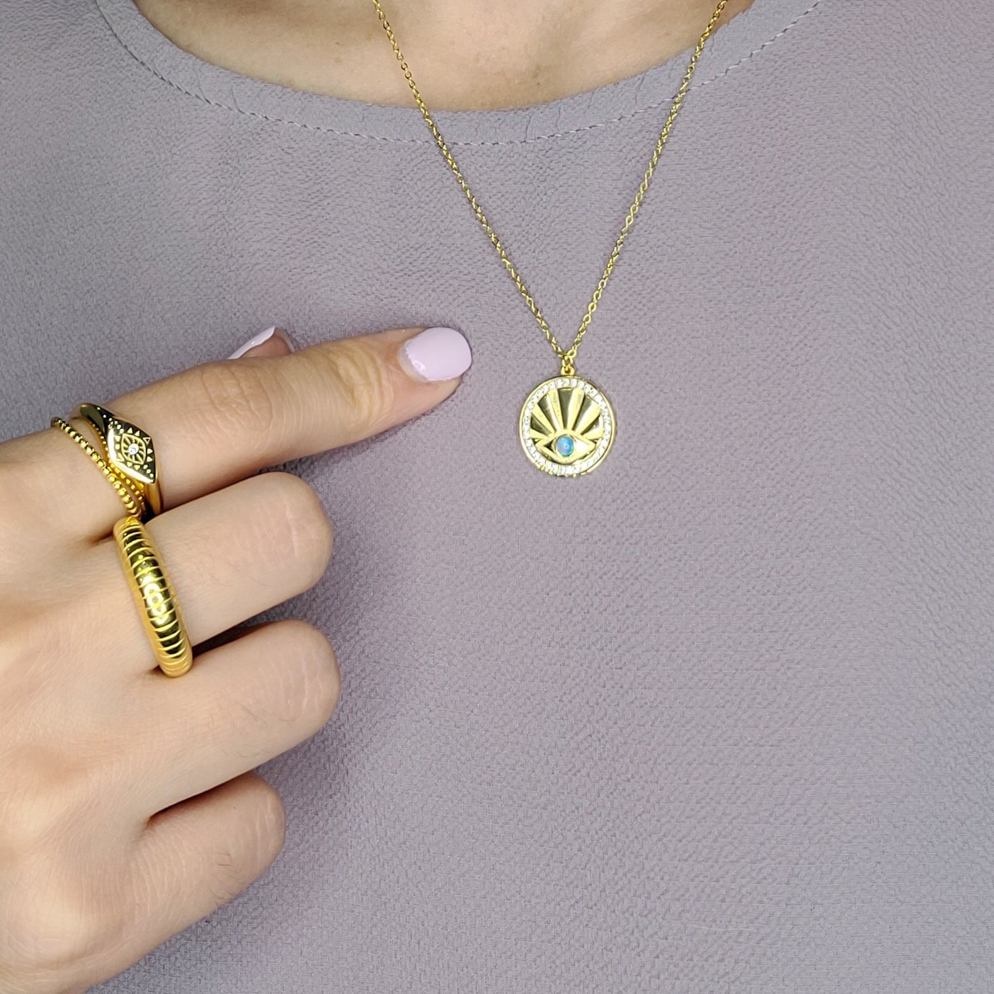 Model wearing sterling silver evil eye ring