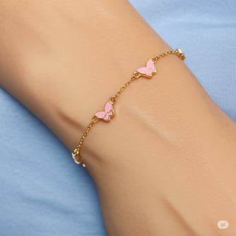 Woman wearing a 10kt yellow gold butterfly bracelet