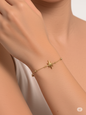 Woman wearing fine 10kt yellow gold bracelet with Northern Star