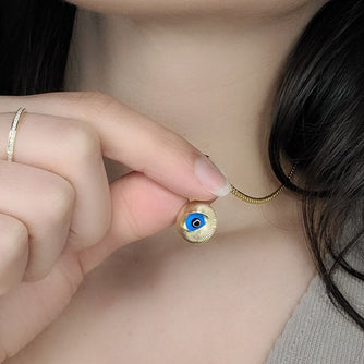 Woman wearing evil eye medallion 1