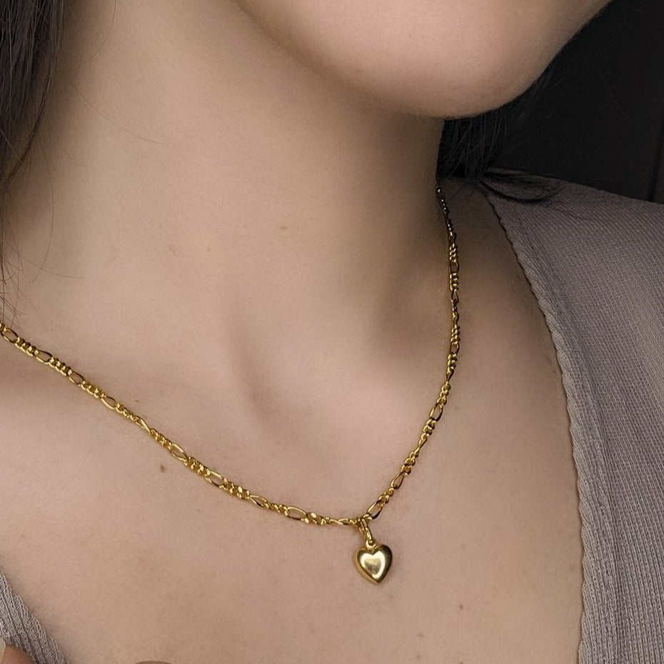Woman wearing heart pendant