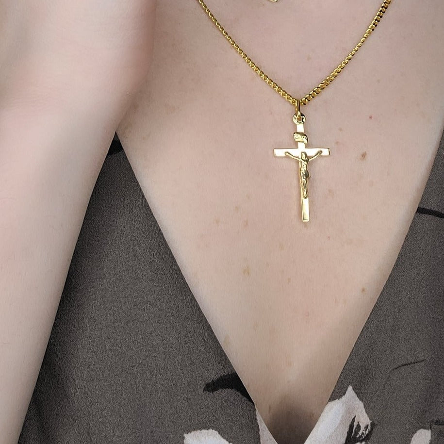 Woman wearing crucifix and heart necklace