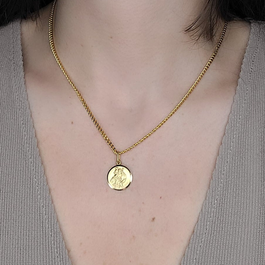 Woman wearing st Christopher medallion