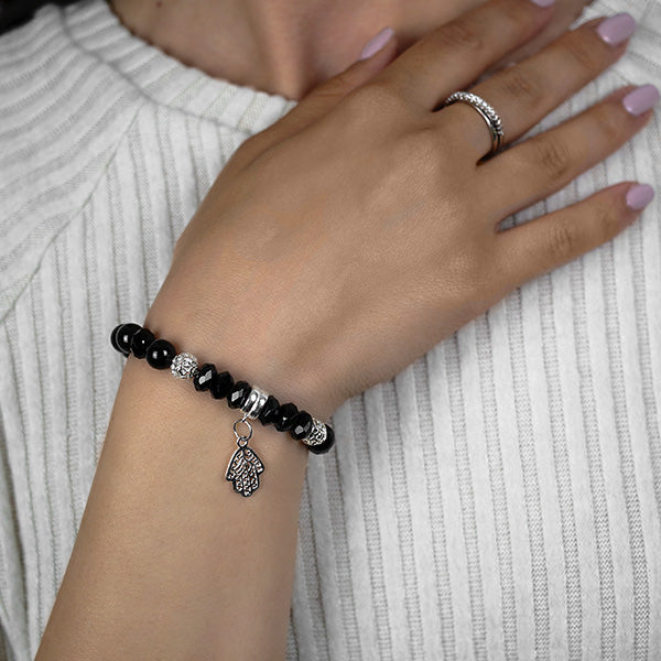 Multi-faceted Black Obsidian Sterling Silver Beads and Hamsa Charm Worn by Woman