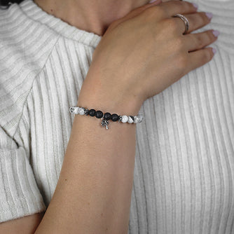 Green Tourmaline and Black Lave Beaded Bracelet with Sterling Silver Spacer Beads and Charm Worn by Woman