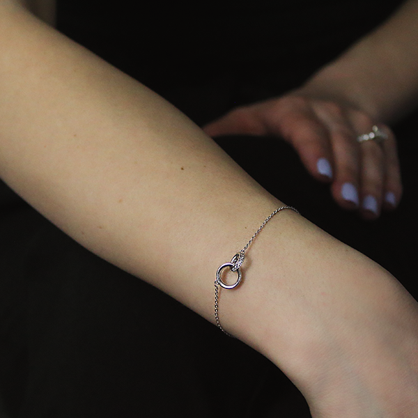 Silver Coupled Ring Bracelet with Cubic Zirconia worn by a woman