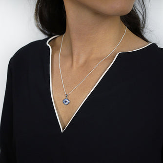 Sterling Silver Evil Eye Pendant set with Cubic Zirconia and Synthetic Sapphires Worn by Woman with Curb Chain