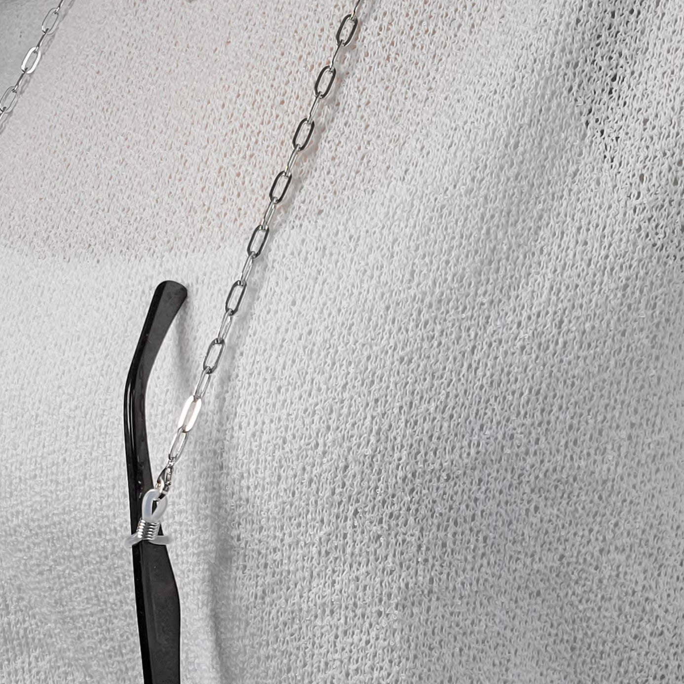 Woman wearing paper clip eye glasses chain