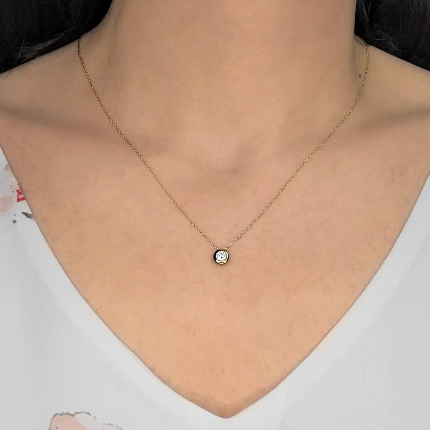 Woman wearing cubic bezel necklace