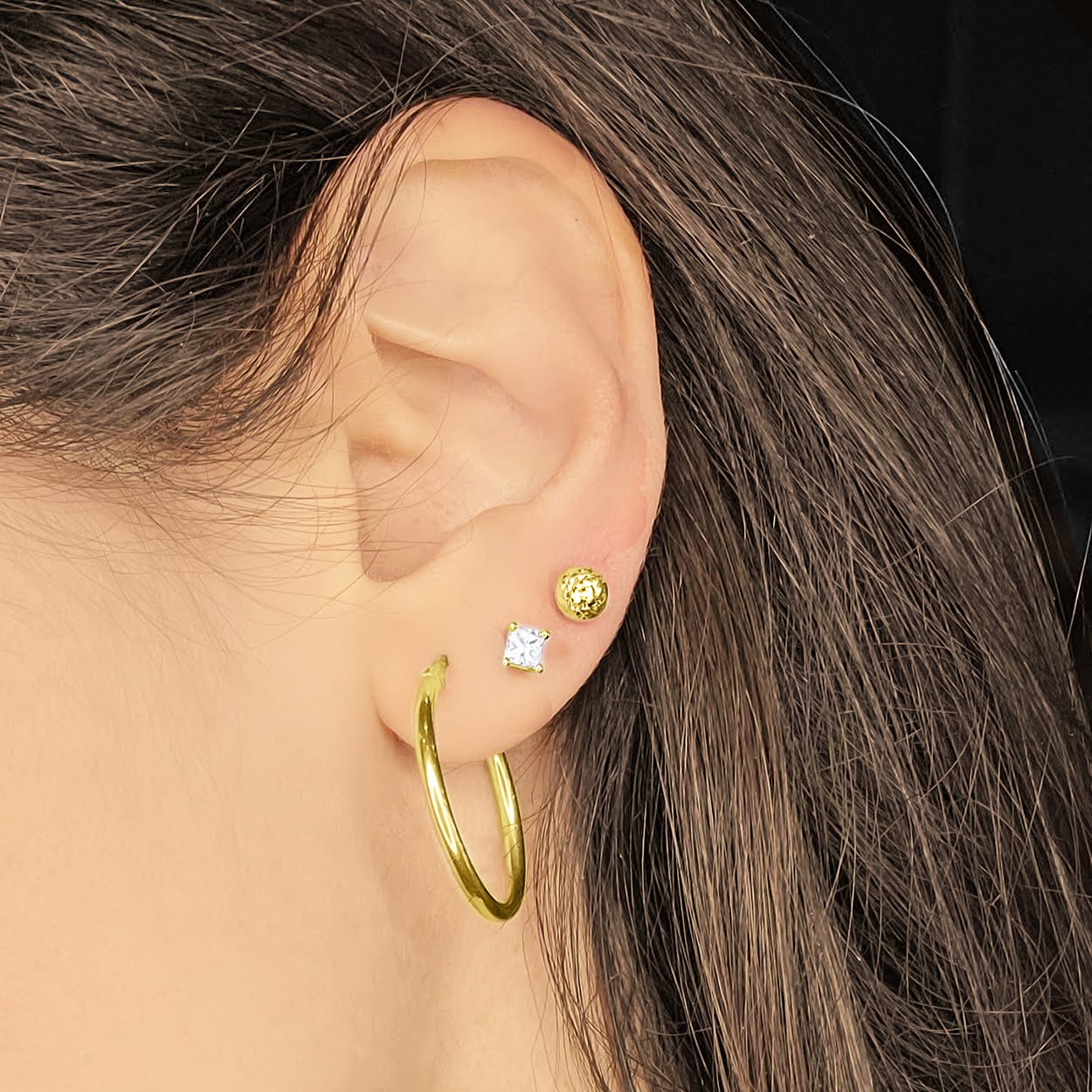 Woman wearing 5mm Cosmo 10KT Yellow Gold Studs