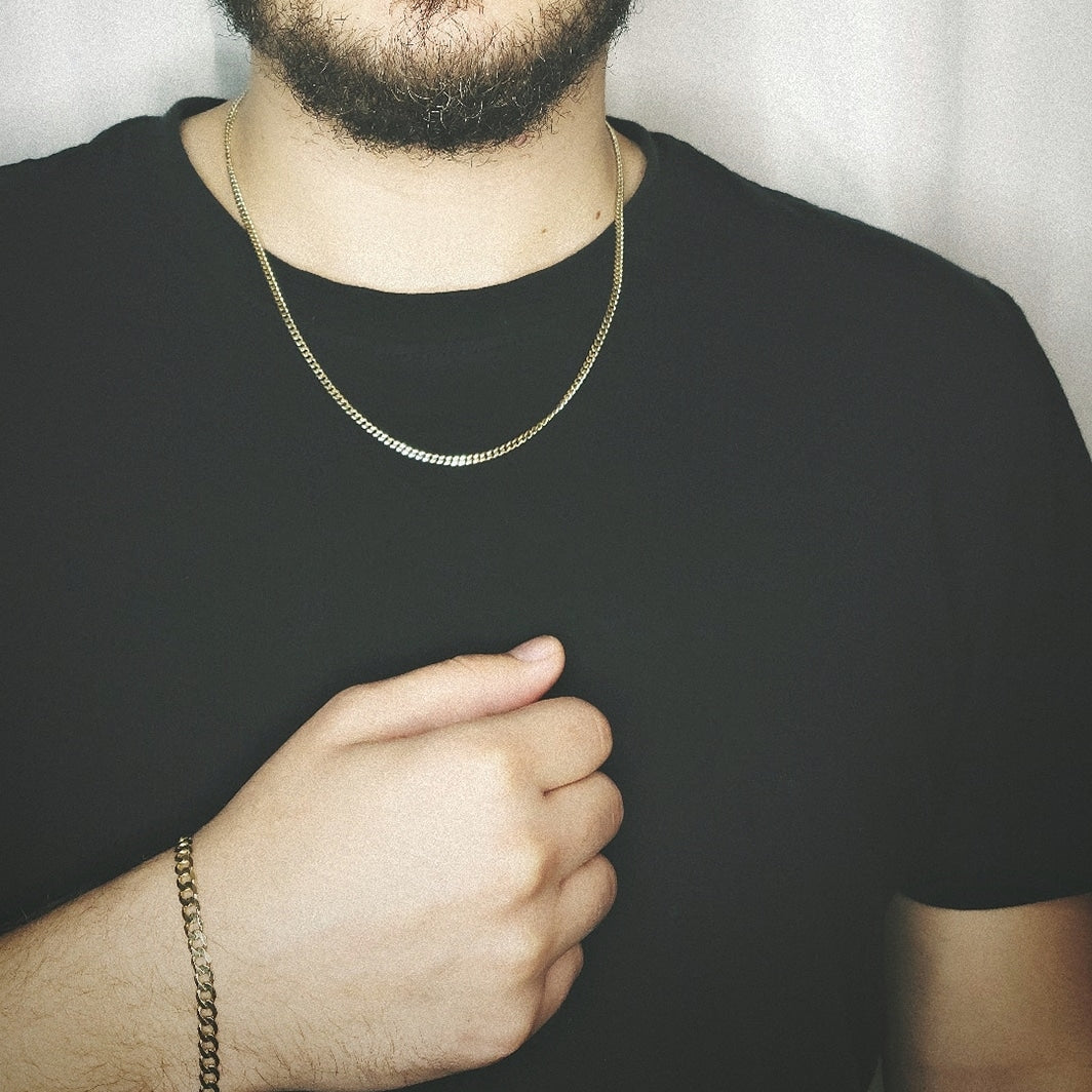 Man wearing curb chain and curb bracelet