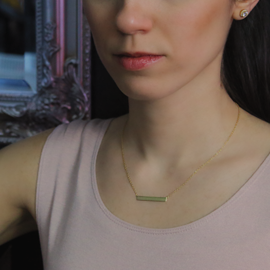 18kt Yellow Gold Plated Bar Necklace Around Woman's Neck