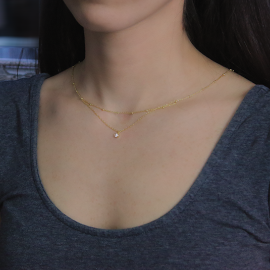 18kt Yellow Gold Plated Layered Necklace with Cubic Zirconia Around Woman's Neck as Sample for Silver