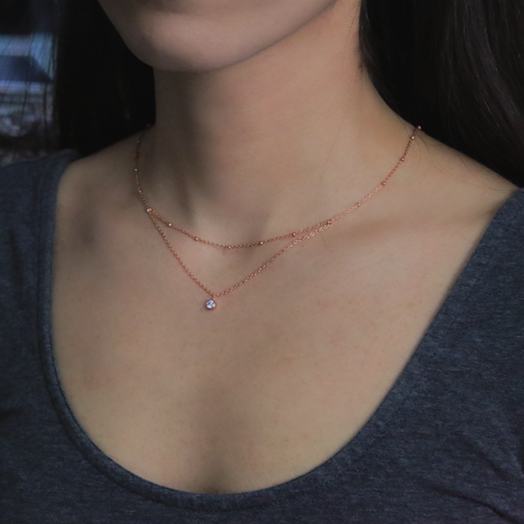 18kt Rose Gold plated Layered Necklace with Cubic Zirconia Around Woman's Neck