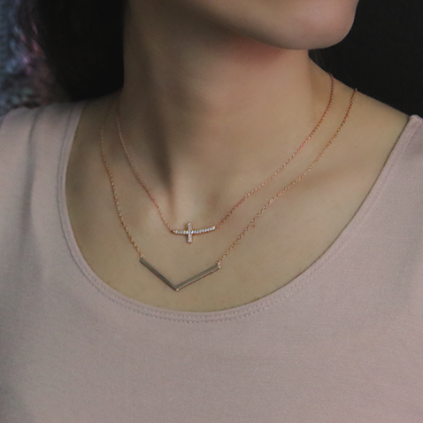 18kt Rose Gold Cubic Zirconia Horizontal Cross Necklace Around Woman's Neck Matched with Freedom Rose Necklace