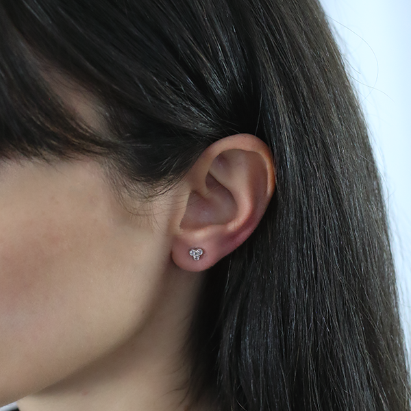 Sterling Silver Trifecta Stud Earrings worn by a woman