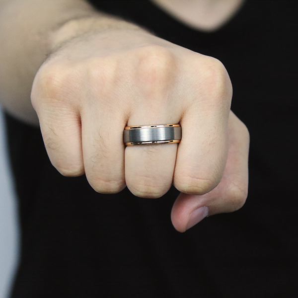 Satin Finished Tungsten Carbide Ring with Rose Gold Plated Edges worn by a man 2