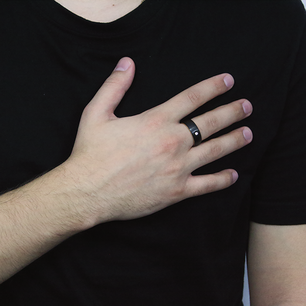 Black Tungsten Carbide Ring with a Brushed Finish and a Yellow-Gold Plated Inlay and one set Cubic Zirconia worn by a man 1