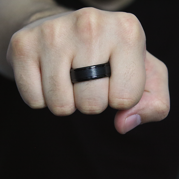 Black Tungsten Carbide Ring with Wire Brush Designed Center worn by a man 2
